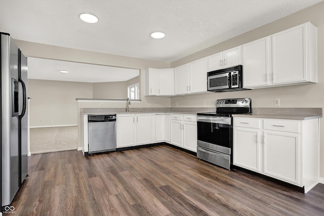 kitchen with white cabinetry, light countertops, dark wood-style flooring, and appliances with stainless steel finishes