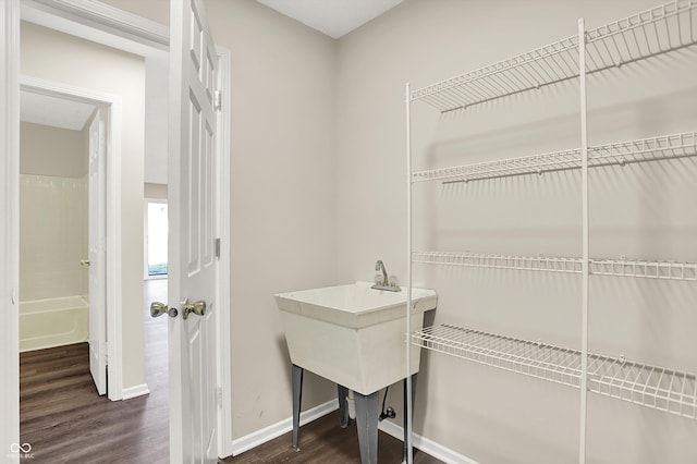 interior space with baseboards and dark wood-type flooring