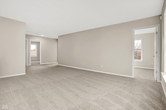 unfurnished room featuring baseboards and carpet flooring