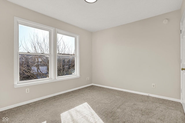 empty room with baseboards and carpet floors