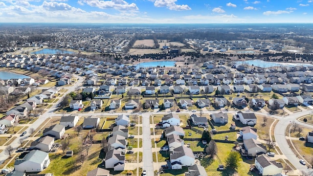 bird's eye view featuring a water view and a residential view