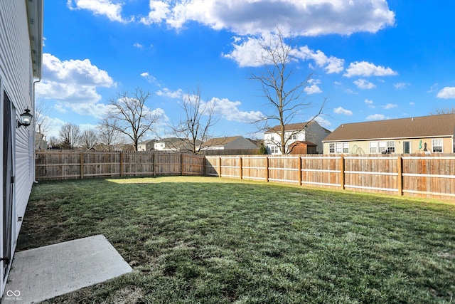 view of yard with a residential view and a fenced backyard