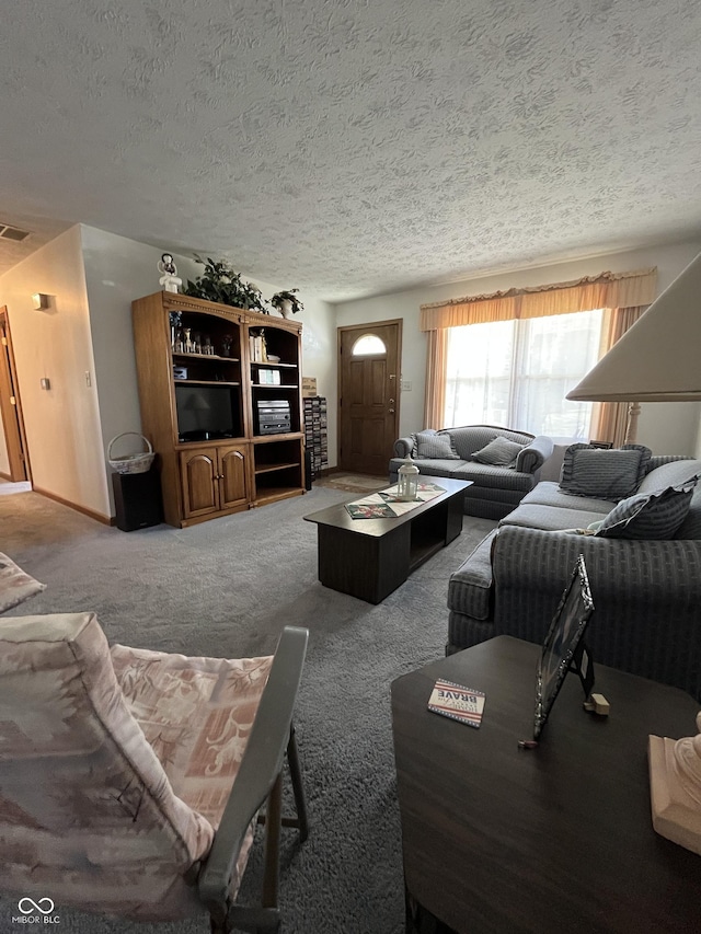 carpeted living room with visible vents and a textured ceiling