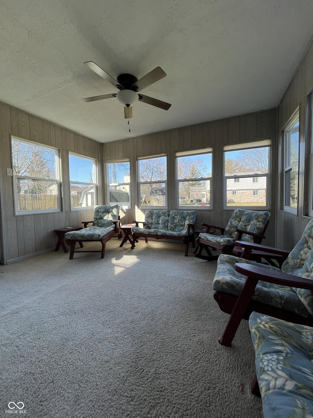 sunroom featuring plenty of natural light and a ceiling fan