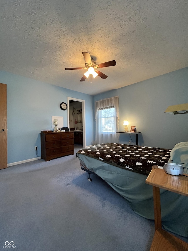 carpeted bedroom featuring a textured ceiling, baseboards, and ceiling fan