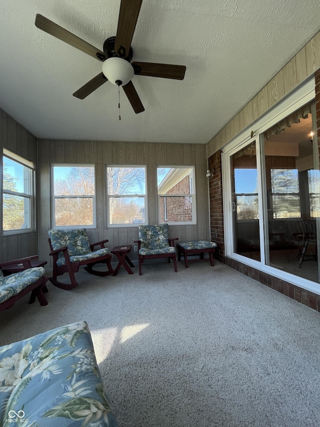 unfurnished sunroom with a ceiling fan