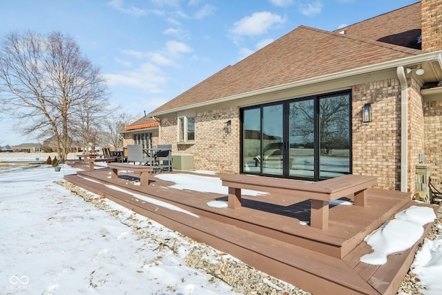 snow covered deck featuring outdoor dining area