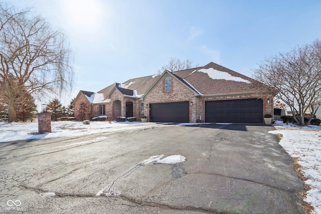 view of front facade featuring brick siding and driveway