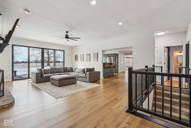 living area with light wood-style flooring, recessed lighting, baseboards, and ceiling fan