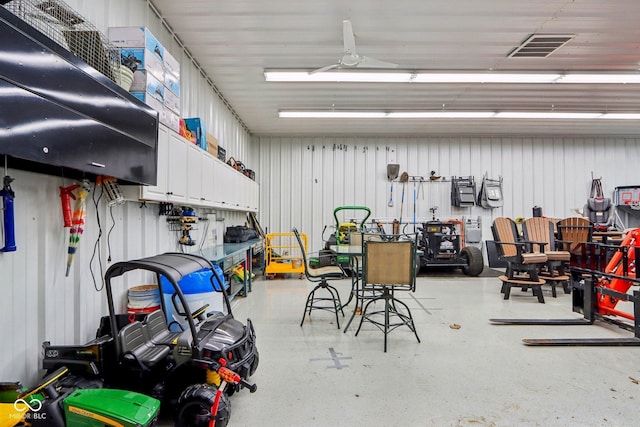 garage featuring a ceiling fan, metal wall, and visible vents