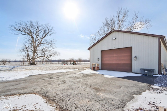 snow covered garage with a garage