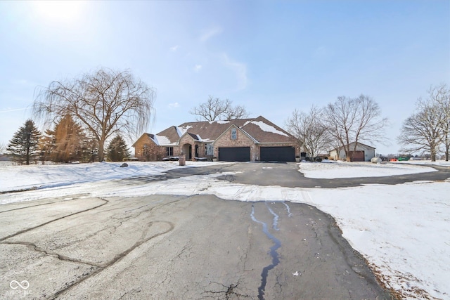 view of front of property with aphalt driveway and an attached garage