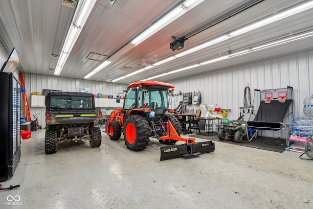 garage with visible vents, a garage door opener, and metal wall