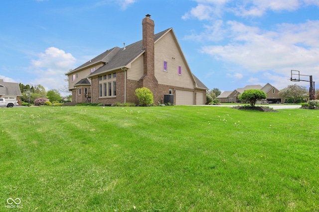 view of side of property with an attached garage, brick siding, central AC unit, a chimney, and a yard