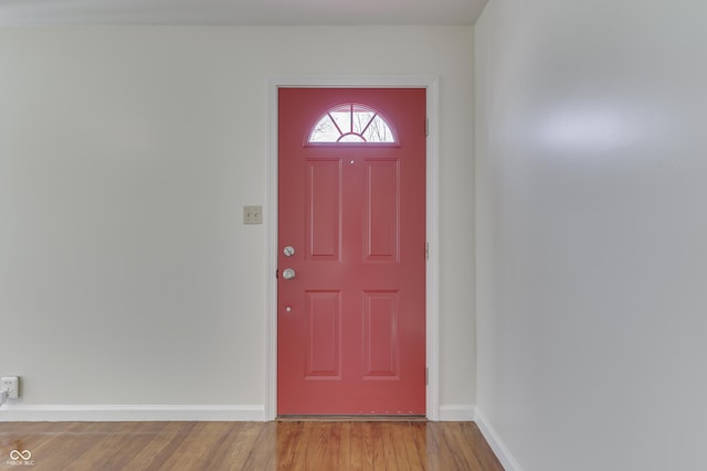 foyer entrance with baseboards and wood finished floors