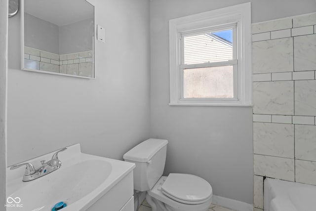 bathroom featuring vanity, a tub to relax in, baseboards, a shower, and toilet