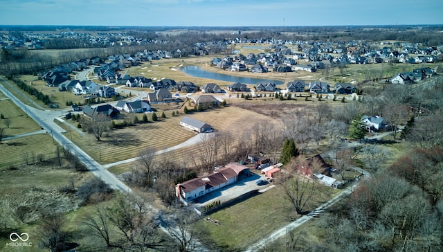 birds eye view of property with a rural view, a residential view, and a water view