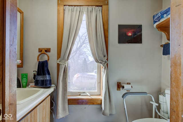 bathroom featuring vanity and toilet