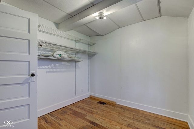 interior space with wood finished floors and visible vents