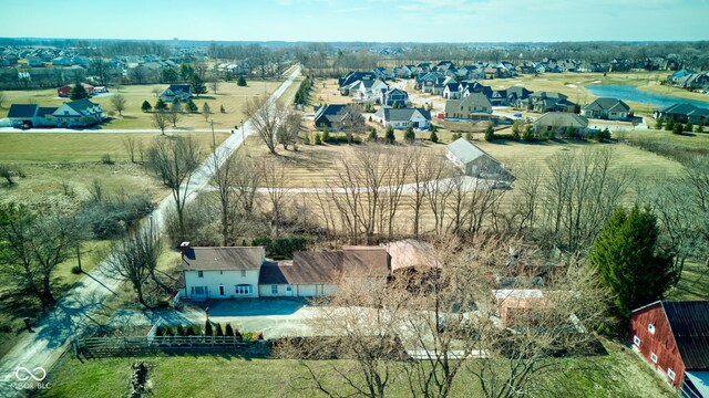 drone / aerial view featuring a residential view and a rural view