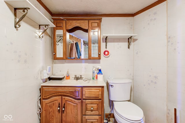 bathroom featuring toilet, vanity, and a textured ceiling