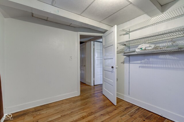 interior space with baseboards and light wood finished floors