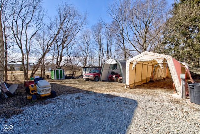 view of yard with a storage shed and an outdoor structure