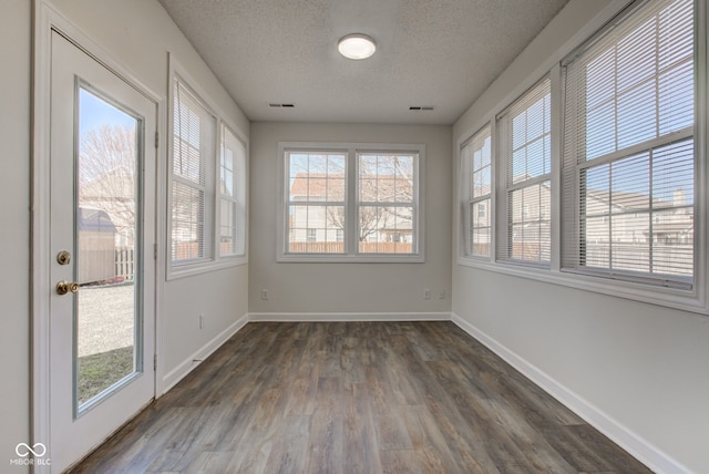 unfurnished sunroom featuring visible vents