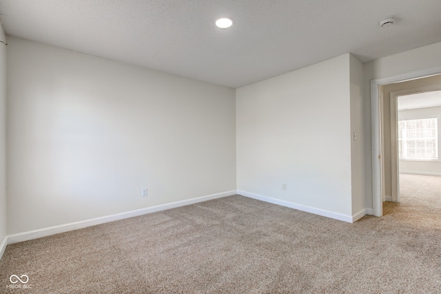 carpeted empty room with recessed lighting and baseboards