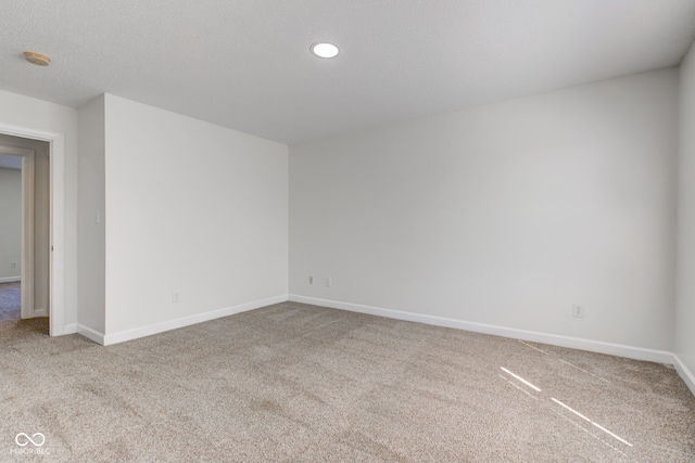 unfurnished room featuring carpet flooring, recessed lighting, a textured ceiling, and baseboards