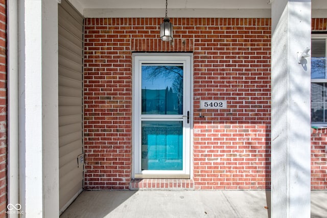 view of exterior entry with brick siding