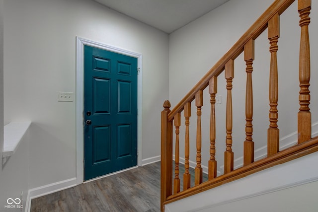 entryway with stairway, baseboards, and wood finished floors