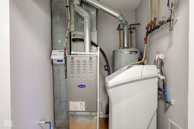 utility room featuring visible vents and water heater