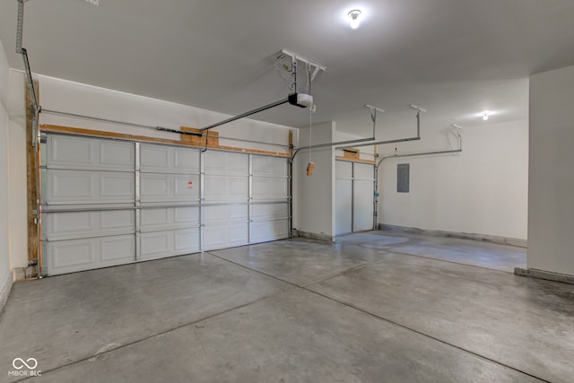 garage with electric panel, a garage door opener, and baseboards