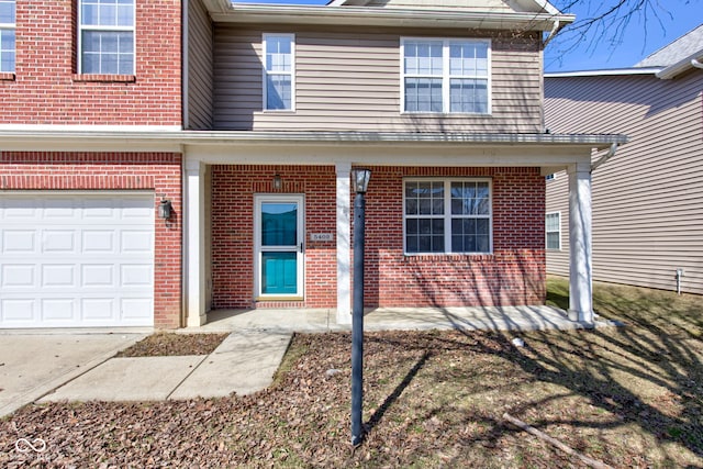 view of exterior entry featuring brick siding