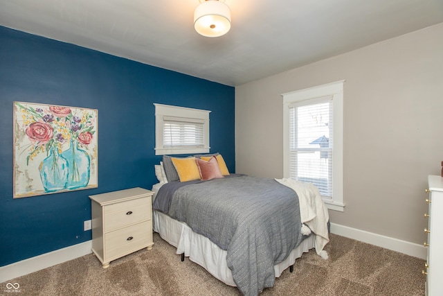 bedroom with baseboards and carpet floors