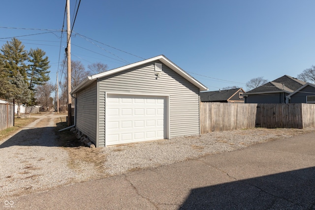 detached garage featuring fence