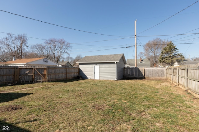 view of yard featuring a fenced backyard, a storage unit, and an outdoor structure