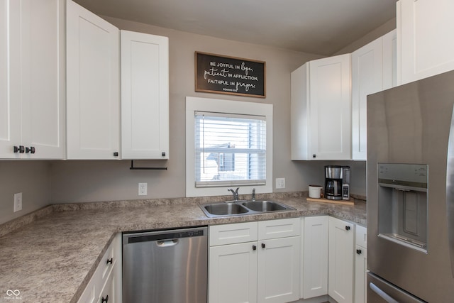 kitchen featuring a sink, white cabinets, and stainless steel appliances