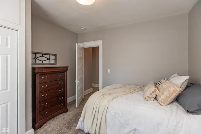 bedroom featuring light colored carpet and baseboards