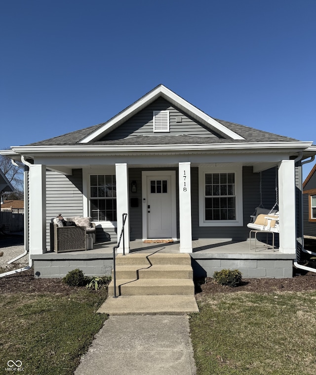 bungalow-style home featuring a porch and a shingled roof