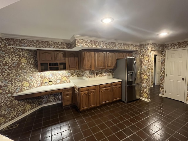 kitchen featuring crown molding, light countertops, stainless steel fridge with ice dispenser, and wallpapered walls