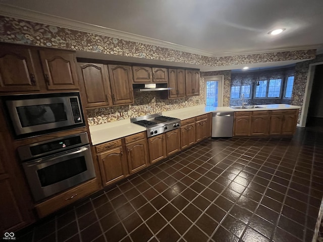 kitchen with a sink, stainless steel appliances, light countertops, under cabinet range hood, and crown molding