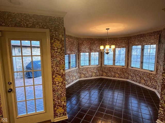 unfurnished dining area featuring wallpapered walls, crown molding, a notable chandelier, and baseboards