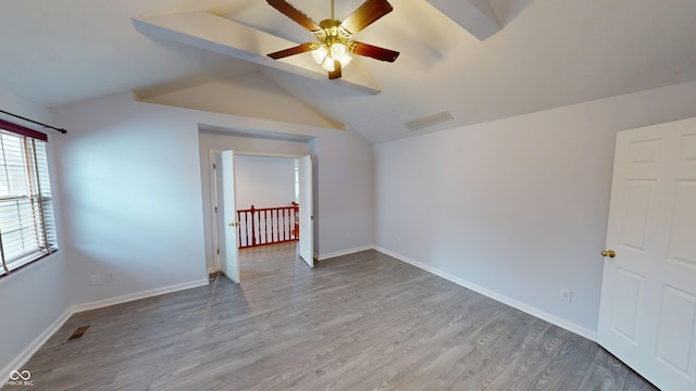 unfurnished room with visible vents, baseboards, and wood finished floors