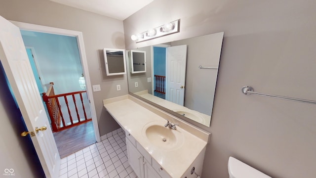 bathroom featuring tile patterned floors, toilet, and vanity