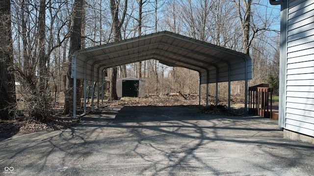 view of parking featuring a detached carport and driveway