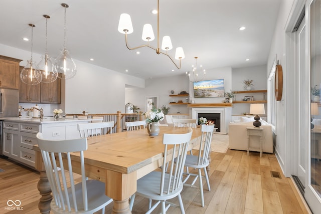 5189 Abbeygate Blvd, Bargersville, IN 46106 - dining area featuring recessed lighting, visible vents, light wood-style floors, and a warm lit fireplace