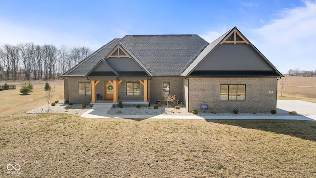 craftsman inspired home featuring metal roof, brick siding, a front yard, and a standing seam roof