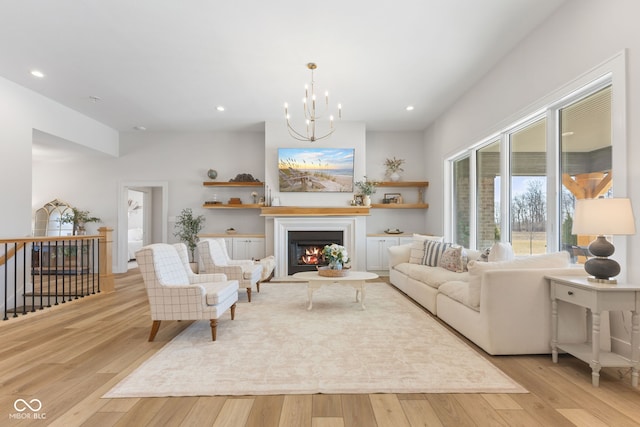 5189 Abbeygate Blvd, Bargersville, IN 46106 - living room with an inviting chandelier, recessed lighting, wood finished floors, and a lit fireplace